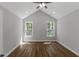 Spacious bedroom with vaulted ceiling, natural light from two windows, and wood-look floors at 4120 Whatuthink Rd., Myrtle Beach, SC 29588