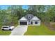 Attractive home with a large driveway, well-maintained lawn, and modern black and white accents at 4120 Whatuthink Rd., Myrtle Beach, SC 29588