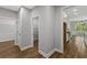 Hallway view leading to kitchen, pantry and storage with modern design and wood-look floors at 4120 Whatuthink Rd., Myrtle Beach, SC 29588