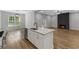 Open kitchen with island flows into a spacious living area with fireplace at 4120 Whatuthink Rd., Myrtle Beach, SC 29588