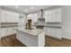 Stylish kitchen featuring white cabinetry, a center island, stainless steel appliances, and granite countertops at 4120 Whatuthink Rd., Myrtle Beach, SC 29588