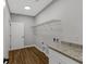 Charming laundry room with wood-look flooring, wire shelving, granite counters and plenty of storage space at 4120 Whatuthink Rd., Myrtle Beach, SC 29588