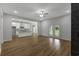 Open-concept living area with hardwood floors and an eat-in kitchen and a door to the backyard at 4120 Whatuthink Rd., Myrtle Beach, SC 29588