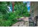 Backyard patio surrounded by lush greenery and mature trees at 4294 Rivergate Ln., Little River, SC 29566