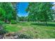 Expansive backyard lawn with mature trees, creating a peaceful and private outdoor setting at 4294 Rivergate Ln., Little River, SC 29566