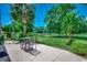 Backyard patio with lawn and lush trees, providing a serene outdoor space at 4294 Rivergate Ln., Little River, SC 29566
