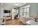 Bright bedroom features a large window with shutters, a desk, and hardwood floors at 4294 Rivergate Ln., Little River, SC 29566