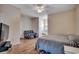 Comfortable bedroom with ceiling fan, hardwood floors, and sitting area with accent chair at 4294 Rivergate Ln., Little River, SC 29566