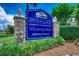 Elegant community sign for Rivergate Whispering Woods, featuring stone pillars and lush landscaping at 4294 Rivergate Ln., Little River, SC 29566