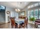Formal dining room with shuttered windows, chandelier, and staircase at 4294 Rivergate Ln., Little River, SC 29566