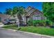 Charming home with stone accents, a landscaped yard, and a welcoming entrance with a palm tree at 4294 Rivergate Ln., Little River, SC 29566