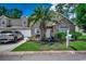 Charming home with stone accents, a landscaped yard, and a welcoming entrance with a palm tree at 4294 Rivergate Ln., Little River, SC 29566