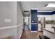 Hallway leading into the kitchen, showcasing white cabinets and stainless steel appliances at 4294 Rivergate Ln., Little River, SC 29566