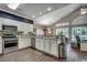 Open kitchen with stainless steel appliances, breakfast bar and modern white cabinets at 4294 Rivergate Ln., Little River, SC 29566