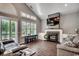 Bright living room with fireplace, shuttered windows, wood floors and comfortable seating at 4294 Rivergate Ln., Little River, SC 29566
