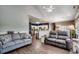 Open-concept living room featuring a gray sofa, leather loveseat, and hardwood floors at 4294 Rivergate Ln., Little River, SC 29566