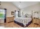 Spacious primary bedroom with hardwood floors, a ceiling fan, and large windows that offer abundant light at 4294 Rivergate Ln., Little River, SC 29566
