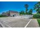 Community pool area with a white picket fence, outdoor seating, and parking spaces in view at 4294 Rivergate Ln., Little River, SC 29566
