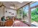 Relaxing sun room with large windows, ceiling fan, and tiled floor at 4294 Rivergate Ln., Little River, SC 29566