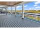 Large covered back porch with wood ceiling and deck flooring with views of the canal and community at 437 Saint Julian Ln., Myrtle Beach, SC 29579