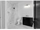 Modern bathroom with a walk-in shower with marble tile and a black vanity at 437 Saint Julian Ln., Myrtle Beach, SC 29579