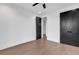 A bright bedroom features hardwood floors, a ceiling fan, and black doors at 437 Saint Julian Ln., Myrtle Beach, SC 29579