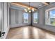 Elegant bedroom features a modern light fixture and scenic views from the bright windows and lovely hardwood floors at 437 Saint Julian Ln., Myrtle Beach, SC 29579