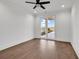 A bright bedroom with hardwood floors features a glass door leading to the pool and lake at 437 Saint Julian Ln., Myrtle Beach, SC 29579