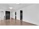 Hallway features beautiful hardwood flooring and white walls with black doors at 437 Saint Julian Ln., Myrtle Beach, SC 29579