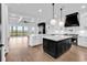 Open concept kitchen with double islands, white cabinets, dark island, and view of the outdoor space at 437 Saint Julian Ln., Myrtle Beach, SC 29579