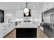 Contemporary kitchen featuring an island, stainless steel appliances, white cabinets and marble countertops at 437 Saint Julian Ln., Myrtle Beach, SC 29579