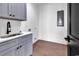A laundry room features cabinets, a sink, and sleek countertops at 437 Saint Julian Ln., Myrtle Beach, SC 29579