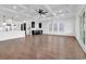 Large open-concept living space with hardwood floors, coffered ceiling, kitchen, and black wet bar at 437 Saint Julian Ln., Myrtle Beach, SC 29579