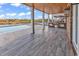 Covered outdoor kitchen and patio area perfect for entertaining, featuring a built-in grill and serene water views at 437 Saint Julian Ln., Myrtle Beach, SC 29579