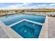 Gorgeous swimming pool and jacuzzi offer a relaxing outdoor experience with serene water views in the background at 437 Saint Julian Ln., Myrtle Beach, SC 29579