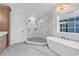 Luxury bathroom showcasing a soaking tub, a tiled walk-in shower, and updated hardware at 441 Saint Julian Ln., Myrtle Beach, SC 29579