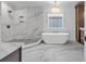 Elegant bathroom features a soaking tub, walk-in shower with marble tiles, and modern fixtures at 441 Saint Julian Ln., Myrtle Beach, SC 29579