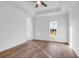 A well-lit bedroom features tray ceiling, beautiful hardwood floors and a large window at 441 Saint Julian Ln., Myrtle Beach, SC 29579