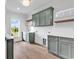 Well-lit laundry room with ample cabinet space, a utility sink, and hardwood floors at 441 Saint Julian Ln., Myrtle Beach, SC 29579