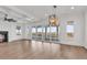 Bright living room with large windows offering picturesque water views and a cozy fireplace at 441 Saint Julian Ln., Myrtle Beach, SC 29579