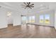 Spacious living room with a tray ceiling, ceiling fan, and large windows offering great natural light at 441 Saint Julian Ln., Myrtle Beach, SC 29579