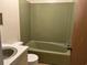 A well-kept bathroom features a matching toilet, sink, and vintage tub-shower combo at 444 Davis Rd., Hemingway, SC 29554