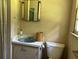 Modest bathroom features a vanity with a blue sink and a standard toilet at 444 Davis Rd., Hemingway, SC 29554