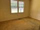Standard bedroom with neutral tones, large window offering natural lighting, and carpeted floor at 444 Davis Rd., Hemingway, SC 29554