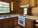 Efficient kitchen design featuring a double sink, electric range, and ample cabinet space at 444 Davis Rd., Hemingway, SC 29554