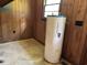 A functional utility space showcasing a water heater with wood paneling at 444 Davis Rd., Hemingway, SC 29554