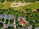 Aerial view of a home nestled among lush trees in a neighborhood, with a golf course nearby at 4803 Bucks Bluff Dr., North Myrtle Beach, SC 29582