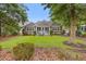 Spacious backyard with a well-manicured lawn, mature trees, and a charming patio at 4803 Bucks Bluff Dr., North Myrtle Beach, SC 29582