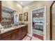 Bathroom featuring double sinks, granite countertops, a tiled shower, and doorway to bedroom at 4803 Bucks Bluff Dr., North Myrtle Beach, SC 29582
