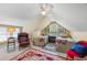Attic bedroom with two beds, a ceiling fan, and a window letting in natural light at 4803 Bucks Bluff Dr., North Myrtle Beach, SC 29582